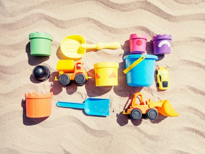 Beach Toys for Children laid out against the sand. 