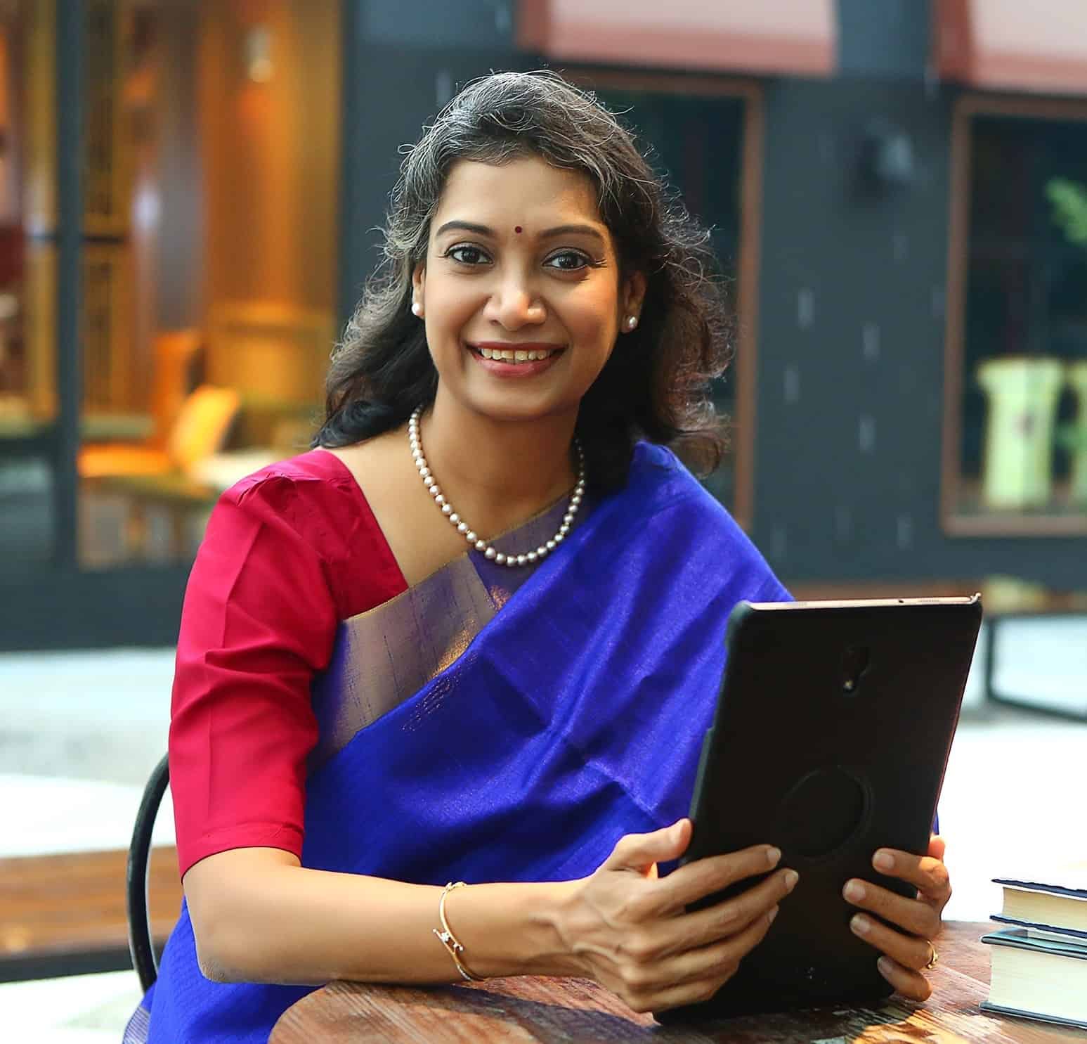 Woman holding iPad Ranjani Rao Author